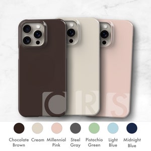 May include: Three phone cases in different colors: chocolate brown, cream, and millennial pink. The cases are made of a clear, flexible material and have a raised lip around the camera lens to protect it from scratches.