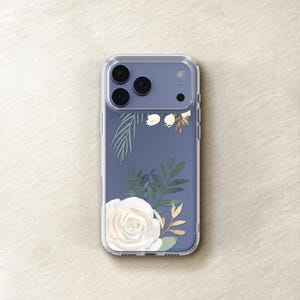 A clear phone case with a floral design on the back cover, featuring a white rose and green leaves.