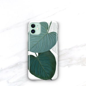 May include: A white phone case with a green leaf design. The leaves are detailed and realistic, with a light green background.