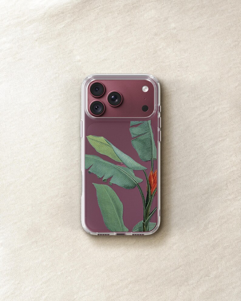 a clear phone case with a design of green leaves and a red flower on the back cover.