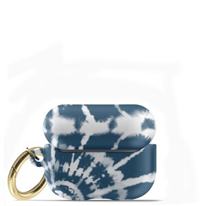 May include: A blue and white tie-dye patterned protective case for AirPods with a gold metal carabiner.