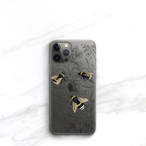 May include: Clear phone case with a black and white floral design and three yellow and black bumblebees.