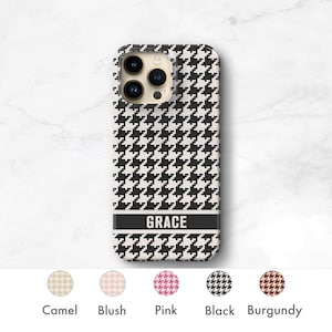 May include: A black and white houndstooth phone case with the name "GRACE" printed in black on a white band. The case is available in camel, blush, pink, black, and burgundy.