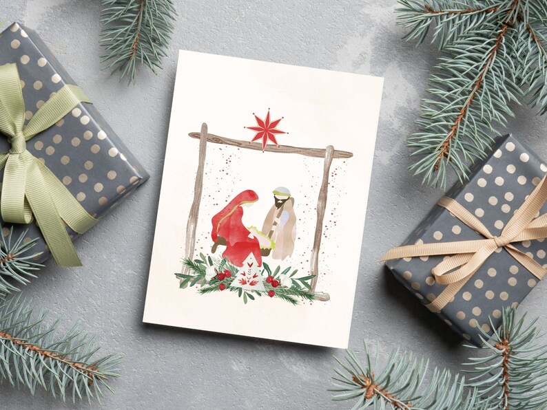 May include: A watercolor Christmas card featuring a nativity scene with Mary, Joseph, and baby Jesus in a manger. The scene is set against a white background with a red star above the manger.