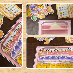 May include: A collage of colorful paper cutouts of baked goods, including cakes, muffins, and croissants, arranged around a pink bakery display case. Several cards with a "List to Bake" theme are also present.