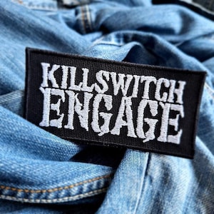 May include: Black and white embroidered patch with the text "Killswitch Engage" in a bold, stylized font.