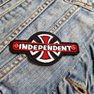 May include: Black and red embroidered patch with a cross shape and the word "Independent" in white lettering.