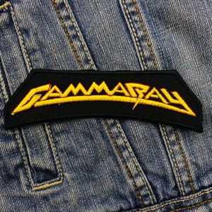 May include: Black and yellow embroidered patch with the band name "GAMMARAY" in a stylised font.