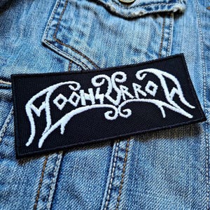 May include: Black and white embroidered patch with the word "Moonsorrow" in a stylised font.