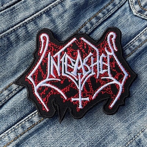 May include: A black and red embroidered patch with the word "INFERNO" in white lettering. The patch has a jagged, flame-like design.