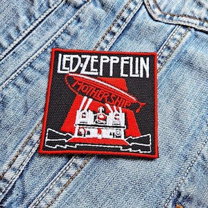 May include: Black and red embroidered patch with the text "LED ZEPPELIN" and "MOTHERSHIP" in white. The patch features a red airship with white details.