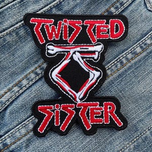 May include: Red and white embroidered patch with the words "Twisted Sister" and a skull and crossbones design.