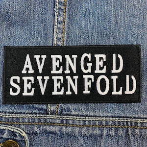 May include: Black patch with white embroidered text that reads "Avenged Sevenfold".