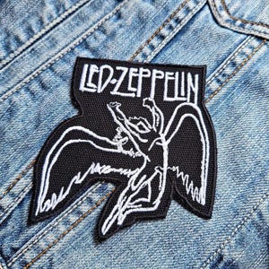 May include: Black and white embroidered patch with the text "LED ZEPPELIN" and a stylized image of a winged figure.