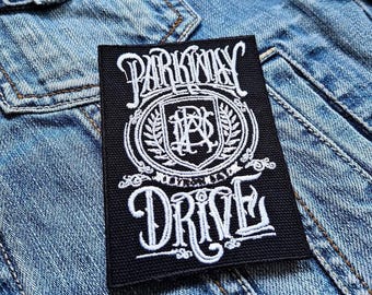 May include: Black and white embroidered patch with the text "Parkway Drive" and a crest featuring the letters "PD" inside a circle.