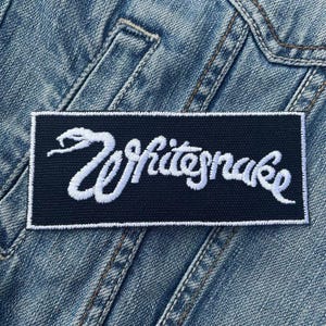 May include: Black and white embroidered patch featuring the text "Whitesnake" and a white snake design.