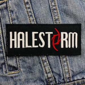 May include: Black and white embroidered patch with the word "HALESTORM" in white lettering and a red stylized lightning bolt.