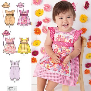 May include: A smiling baby wearing a pink gingham dress with a floral apron and white sandals. The image also shows a Simplicity sewing pattern with illustrations of baby dresses and a sun hat.