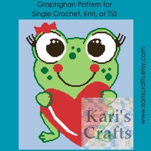May include: A green frog with big eyes and a red heart in its hands. The frog is wearing a red crown and has eyelashes. The frog is smiling. The text "Kari's Crafts" is in the lower right corner of the image.