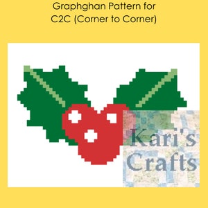 May include: A red heart-shaped holly berry with white dots, surrounded by two green holly leaves with a diagonal green stem. The image is labelled "Kari's Crafts".