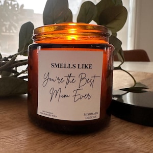 May include: Amber glass jar soy candle with a white label that reads "Smells Like You're the Best Mum Ever". The label also includes the text "Soy Candle 300g/25 Hours Burn" and "Mishmash Designs".
