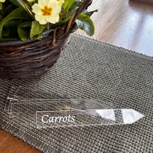 May include: A handmade wooden sign with the word "Welcome" in a whimsical font. The sign has a distressed finish and a simple, rustic design, ideal for a front door or hallway. It measures approximately 30 cm wide.