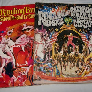 May include: Two vintage Ringling Bros. and Barnum & Bailey Circus programs. One features a roaring tiger on a red background. The other has a black background with circus performers, horses, and tigers.