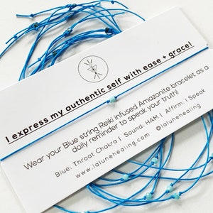 May include: Blue string bracelet with turquoise beads. The card reads "I express my authentic self with ease + grace! Wear your Blue string Reiki infused Amazonite bracelet as a daily reminder to speak your truth! Blue: Throat Chakra | Sound: HAM | Affirm: I Speak www.lalunehealing.com @lalunehealing"