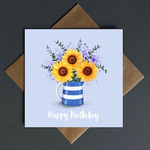 Carte de joyeux anniversaire, un pot de Cornouailles débordant de fleurs vierges à l'intérieur.