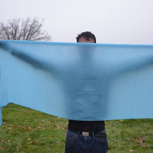 a very large blue cashmere scarf