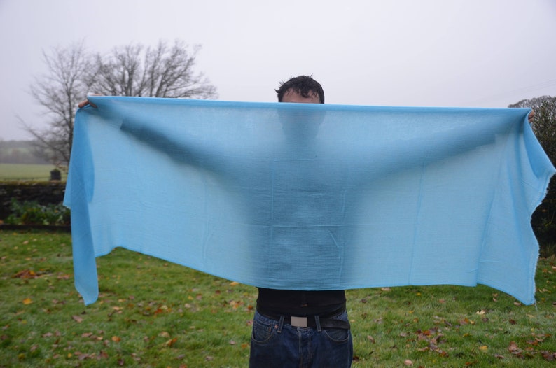 a very large blue cashmere scarf