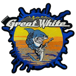Puede incluir: Un parche bordado azul y amarillo con un tiburón de dibujos animados tocando la guitarra. El texto "Great White" está por encima del tiburón. El parche está rodeado por un diseño de salpicaduras azules.