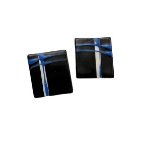 May include: A pair of black square earrings with white and blue abstract lines.