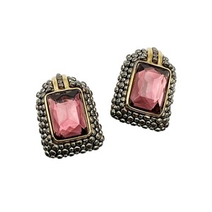 May include: A pair of gold and silver tone earrings with a pink rectangular gem stone in each earring.