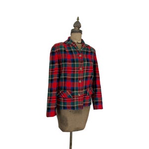 May include: Red, green, and blue plaid blazer with button closure. The blazer has a collar and two pockets.