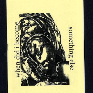 May include: A small, rectangular card with a black and white illustration of a figure, possibly a sculpture or drawing. The text "when did I become" is on the left, and "something else" is on the right. The card has a yellow background.