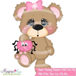 May include: A cartoon illustration of a brown teddy bear with a pink bow and a pink spider. The bear has large eyes and is holding the spider. The image has the text "Marjorie Ann Designs" and "Paper Piecing Pattern-SVG Cut File-PNG Print Then Cut, Clip Art."