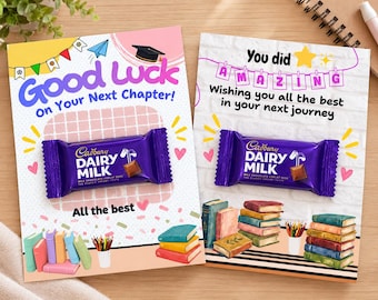 May include: Two rectangular greeting cards featuring Cadbury Dairy Milk chocolate bars attached to the center. The left card says Good Luck On Your Next Chapter! and All the best. The right card says You did AMAZING Wishing you all the best in your next journey, with illustrations of stacked books.