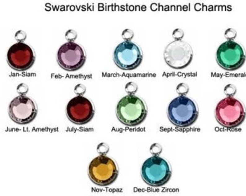 May include: A set of 12 Swarovski birthstone channel charms, each featuring a different colored gemstone. The charms are arranged in a grid, with the month and birthstone name listed below each charm. The charms are perfect for adding a personal touch to jewelry.
