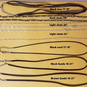 May include: A collection of necklaces with various chain and cord styles. Includes a black lace necklace (17-19 inches), dark chain (20 inches), light chain (20 and 24 inches), black cord (17-19 inches), black suede (18-21 inches), and brown suede (18-21 inches).