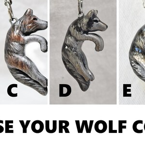 May include: Six different color variations of a wolf pendant charm. The wolf is curled in a circle with its tail curled around its body. The pendant is available in white, black, brown, gray, silver, and black with gold accents.