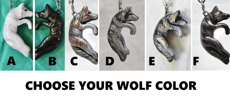 May include: Six different color variations of a wolf pendant charm. The wolf is curled in a circle with its tail curled around its body. The pendant is available in white, black, brown, gray, silver, and black with gold accents.