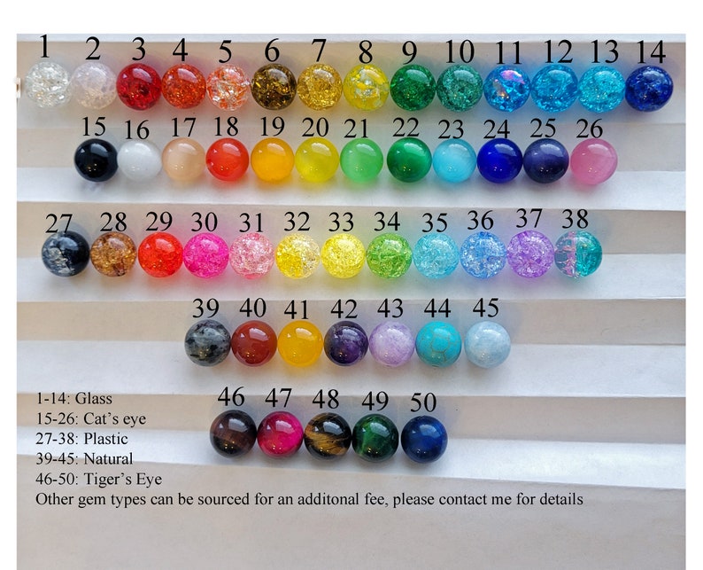 May include: A chart of 50 different beads, numbered 1 to 50. The beads are made of glass, cat's eye, plastic, natural stone, and tiger's eye. The chart includes the text: 1-14: Glass, 15-26: Cat's eye, 27-38: Plastic, 39-45: Natural, 46-50: Tiger's Eye, Other gem types can be sourced for an additional fee, please contact me for details.