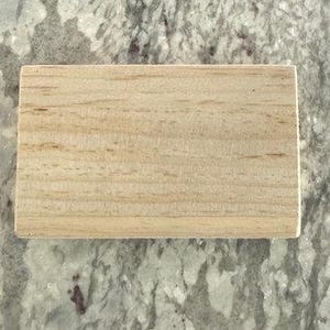 May include: A plain, rectangular wooden block with a light brown color and a smooth surface.