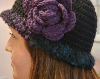 Crocheted Black Hat With Emerald and Purple Variegated Trim and Purple Rose