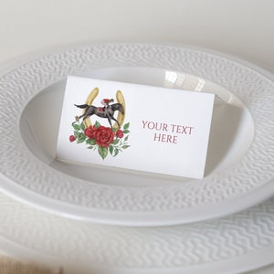 May include: White plates with a textured rim, stacked on a white surface. A small card with a horse illustration, roses, and the text "YOUR TEXT HERE" rests on the top plate. A cleaning brush is in the foreground.