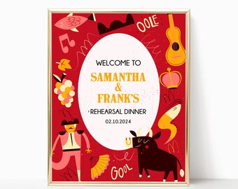 May include: A framed sign with a red background featuring a central white oval containing the text WELCOME TO SAMANTHA & FRANK'S REHEARSAL DINNER 02.10.2024. The border displays illustrations of a bull, a matador, a guitar, grapes, and a fan.