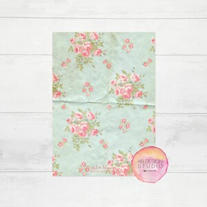 May include: A light blue background with a floral pattern of pink roses. The text "aster bloom design studio" is in the bottom left corner. A pink watercolor circle with the text "AB DESIGN STUDIO" is in the bottom right corner.