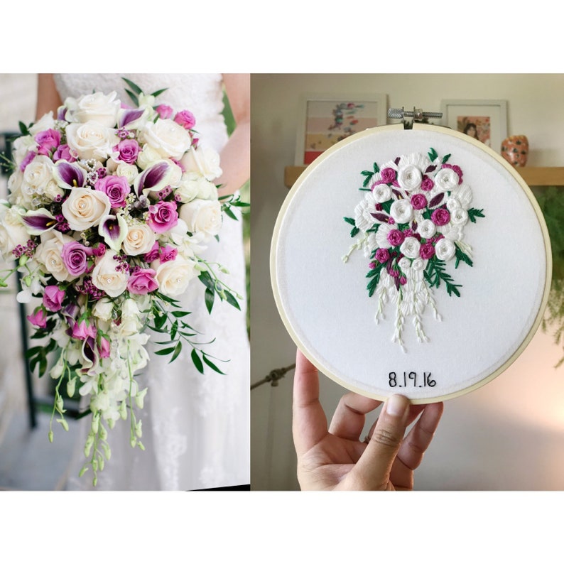 May include: Embroidered hoop art featuring a white and purple floral bouquet with green leaves. The hoop is white with a wooden frame and the date 8.19.16 is embroidered in black thread at the bottom.