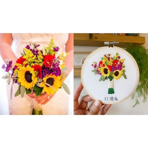 May include: Embroidered hoop art featuring a colorful bouquet of sunflowers, red and purple flowers, and greenery. The hoop is white with a wooden frame and the date "11.18.16" is embroidered in black thread.